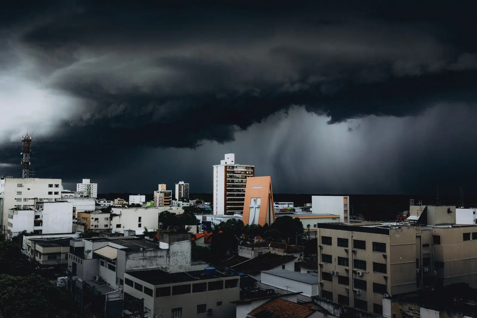 Dark storm clouds over city buildings